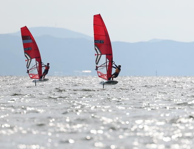 (261003) -- GAMAGORI, Oct. 3, 2026 (Xinhua) -- Wong Tsz Ho (R) of China's Hong Kong and Wong John Tze Xiang of Singapore compete during the Boys' Windsurfing Opening Series Race of Sailing at the 20th Asian Games Aichi-Nagoya 2026 in Gamagori of Aichi Prefecture, Japan, Oct. 3, 2026. (Xinhua/Deng Hua)