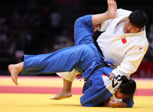 (261003) -- NAGOYA, Oct. 3, 2026 (Xinhua) -- Niu Xinran of China (top) competes against Aidemi Imanovna Kalyeva of Kyrgyzstan during the mixed team repechage match of Judo at the 20th Asian Games Aichi-Nagoya 2026 in Nagoya, Japan, Oct. 3, 2026. (Xinhua/Yao Qilin)