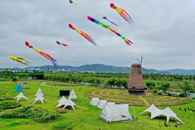 (261003) -- BEIJING, Oct. 3, 2026 (Xinhua) -- A drone photo shows people having fun at a wetland park in Yuhuan, east China's Zhejiang Province, Oct. 2, 2026.
  China's cultural and tourism market is thriving during this year's National Day holiday, with a wide range of options including scenic getaways, autumn outings, tourism with revolutionary topics, nighttime entertainment, and cultural tours featuring the country's intangible cultural heritage. (Photo by Duan Junli/Xinhua)