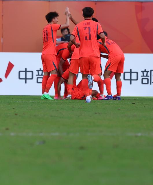 (261003) -- TOYOTA, Oct. 3, 2026 (Xinhua) -- Players of China celebrate a goal during the men's 3rd place match of football between China and Uzbekistan at 20th Asian Games Aichi-Nagoya 2026 in Toyota of Aichi Prefecture, Japan, Oct. 3, 2026. (Xinhua/Jia Haocheng)