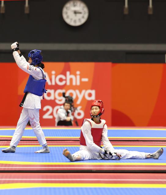(261003) -- TOYOHASHI, Oct. 3, 2026 (Xinhua) -- Zhang Chuling (L) of China reacts after her match with Lin Wei-chun of Chinese Taipei during the women -57kg semifinal of taekwondo at the 20th Asian Games Aichi-Nagoya 2026 in Toyohashi of Aichi Prefecture, Japan, Oct. 3, 2026. (Xinhua/Wang Fei)