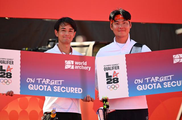 (261003) -- OKAZAKI, Oct. 3, 2026 (Xinhua) -- Lee Wooseok (R) of South Korea and Nakanishi Junya of Japan celebrate securing one quota place each for the Los Angeles 2028 Olympic Games after their Recurve Men's Individual Gold Medal Match of Archery at the 20th Asian Games Aichi-Nagoya 2026 in Okazaki of Aichi Prefecture, Japan, Oct. 3, 2026. (Xinhua/Yu Yang)