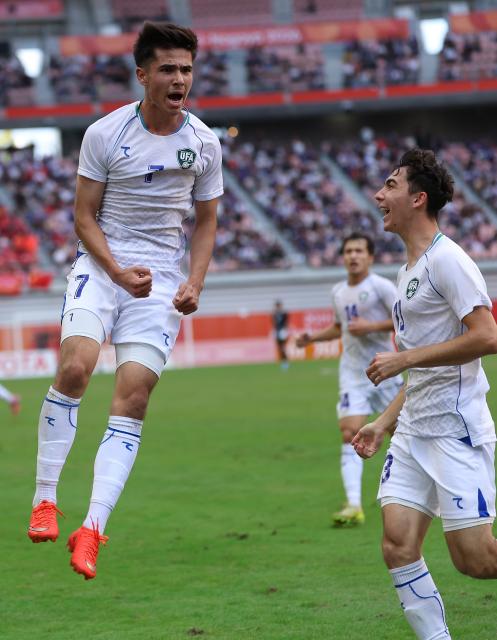 (261003) -- TOYOTA, Oct. 3, 2026 (Xinhua) -- Sardorbek Bakhromov (L) of Uzbekistan celebrates his goal during the men's 3rd place match of football between China and Uzbekistan at 20th Asian Games Aichi-Nagoya 2026 in Toyota of Aichi Prefecture, Japan, Oct. 3, 2026. (Xinhua/Jia Haocheng)