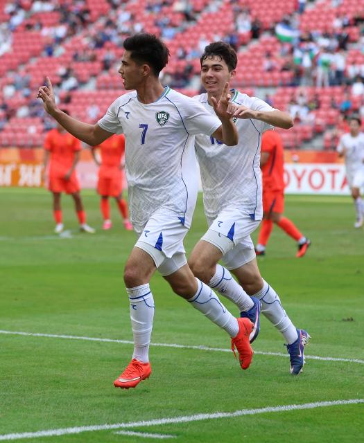 (261003) -- TOYOTA, Oct. 3, 2026 (Xinhua) -- Sardorbek Bakhromov (L) of Uzbekistan celebrates his goal during the men's 3rd place match of football between China and Uzbekistan at 20th Asian Games Aichi-Nagoya 2026 in Toyota of Aichi Prefecture, Japan, Oct. 3, 2026. (Xinhua/Jia Haocheng)