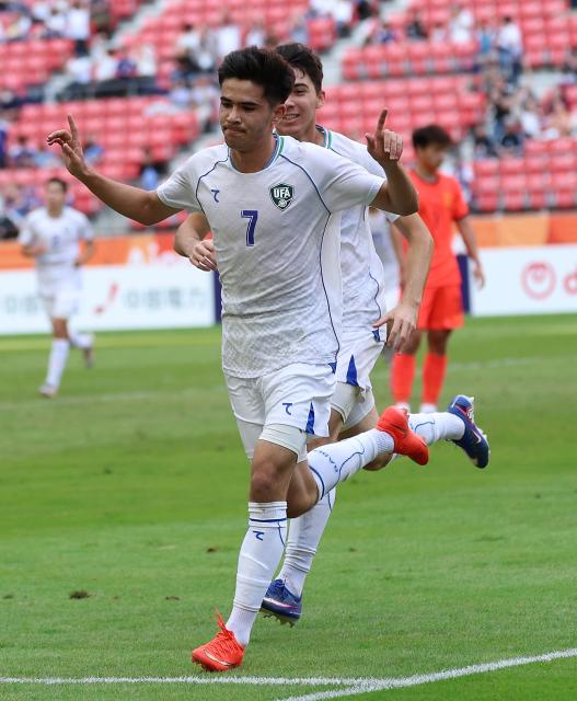 (261003) -- TOYOTA, Oct. 3, 2026 (Xinhua) -- Sardorbek Bakhromov of Uzbekistan celebrates his goal during the men's 3rd place match of football between China and Uzbekistan at 20th Asian Games Aichi-Nagoya 2026 in Toyota of Aichi Prefecture, Japan, Oct. 3, 2026. (Xinhua/Jia Haocheng)