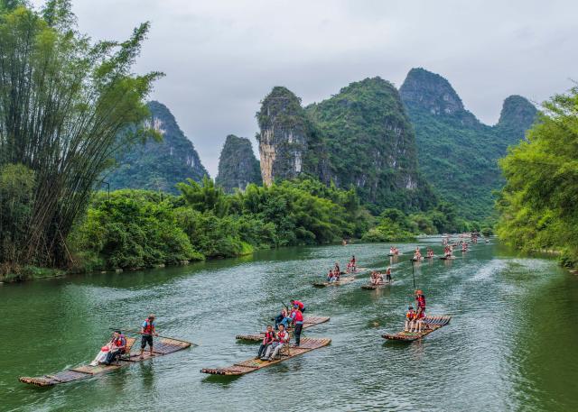 (261003) -- BEIJING, Oct. 3, 2026 (Xinhua) -- A drone photo shows tourists enjoying scenery by raft on the Yulong River in Yangshuo County of Guilin City, south China's Guangxi Zhuang Autonomous Region, Oct. 2, 2026.
  China's cultural and tourism market is thriving during this year's National Day holiday, with a wide range of options including scenic getaways, autumn outings, tourism with revolutionary topics, nighttime entertainment, and cultural tours featuring the country's intangible cultural heritage. (Photo by Jiang Keqing/Xinhua)