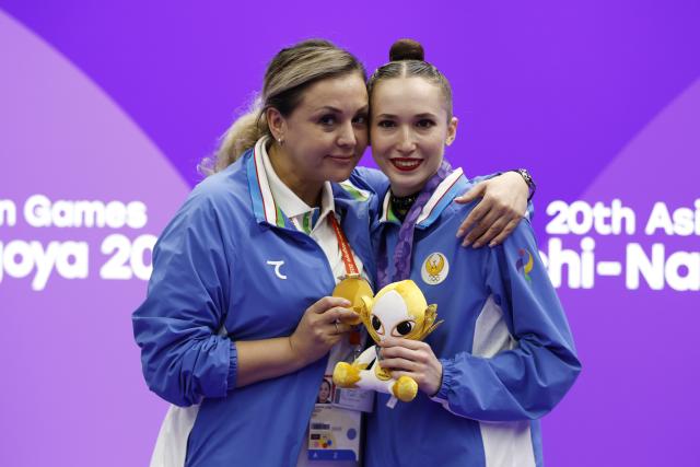 (261003) -- NAGOYA, Oct. 3, 2026 (Xinhua) -- Gold medalist Takhmina Ikromova (R) of Uzbekistan poses for photos after the awarding ceremony for the Individual All-Around of Rhythmic Gymnastics at 20th Asian Games Aichi-Nagoya 2026 in Nagoya, Japan, Oct. 3, 2026. (Xinhua/Wu Zhizun)
