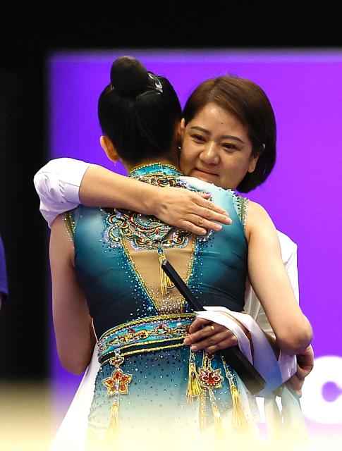 (261003) -- NAGOYA, Oct. 3, 2026 (Xinhua) -- Wang Zilu of China hugs her coach after competing in the Individual All-Around Final of Rhythmic Gymnastics at 20th Asian Games Aichi-Nagoya 2026 in Nagoya, Japan, Oct. 3, 2026. (Xinhua/Wu Zhizun)