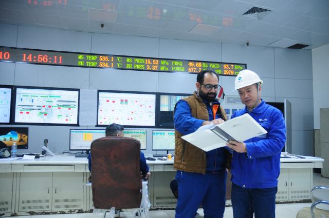 (261003) -- BEIJING, Oct. 3, 2026 (Xinhua) -- Staff members from China and Iraq check the operation of the generator units at the Wasit Power Plant, in Wasit Province, Iraq, Feb. 10, 2025. (Xinhua/Duan Minfu)