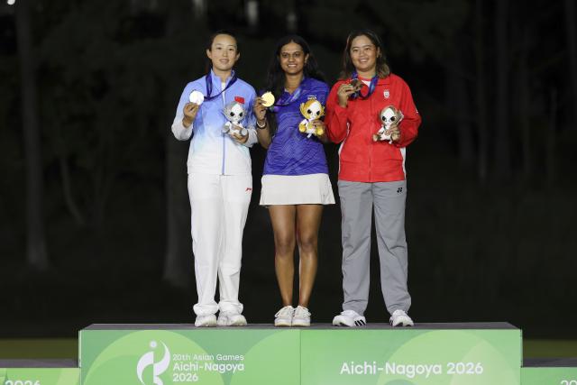 (261003) -- KASUGAI, Oct. 3, 2026 (Xinhua) -- Gold medalist Pranavi Sharath Urs of India, silver medalist Yin Ruoning of China and bronze medalist Tan Shannon Xuan Yin of Singapore pose during the awarding ceremony for the Women's Individual Stroke Play of Golf at 20th Asian Games Aichi-Nagoya 2026 in Kasugai of Aichi Prefecture, Japan, Oct. 3, 2026. (Xinhua/Li Bo)