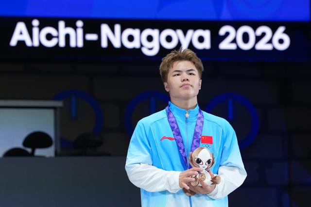 (261003) -- TOKONAME, Oct. 3, 2026 (Xinhua) -- Bronze medalist China's Wang Ruimiao reacts during the awarding ceremony for the B-Boys match of Breaking at the 20th Asian Games Aichi-Nagoya 2026 in Tokoname of Aichi Prefecture, Japan, Oct. 3, 2026. (Xinhua/Cheong Kam Ka)