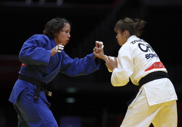 (261003) -- NAGOYA, Oct. 3, 2026 (Xinhua) -- Zhang Wen (R) of team China competes against Anujin Uran-Ulzii of team Mongolia during the mixed team matches for bronze medals of Judo between China and Mongolia at the 20th Asian Games Aichi-Nagoya 2026 in Nagoya, Japan, Oct. 3, 2026. (Xinhua/Yao Qilin)