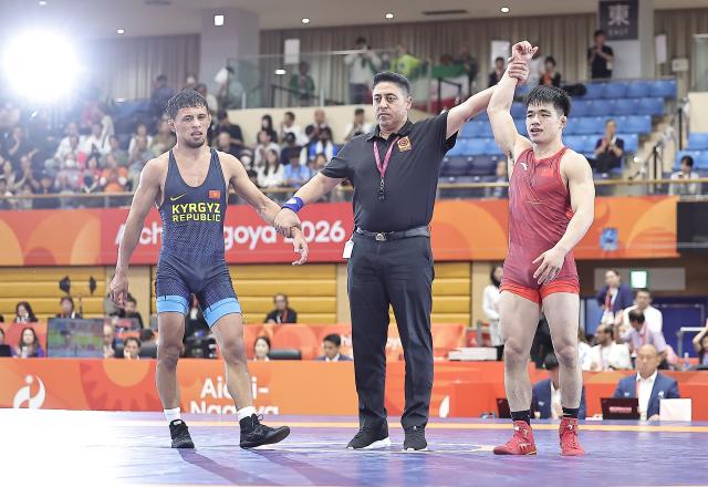 (261003) -- NAGOYA, Oct. 3, 2026 (Xinhua) -- Zou Wanhao (R) of China celebrates after winning the men's freestyle 57kg bronze medal match of Wrestling against Bekzat Almaz Uulu of Kyrgyzstan at the 20th Asian Games Aichi-Nagoya 2026 in Nagoya, Japan, Oct. 3, 2026. (Xinhua/Long Lei)