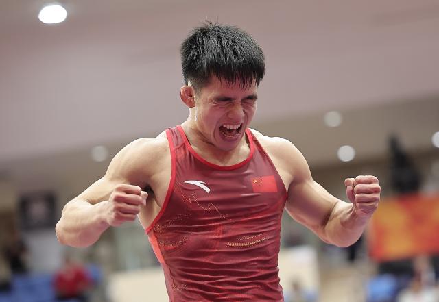(261003) -- NAGOYA, Oct. 3, 2026 (Xinhua) -- Zou Wanhao of China celebrates after winning the men's freestyle 57kg bronze medal match of Wrestling against Bekzat Almaz Uulu of Kyrgyzstan at the 20th Asian Games Aichi-Nagoya 2026 in Nagoya, Japan, Oct. 3, 2026. (Xinhua/Long Lei)