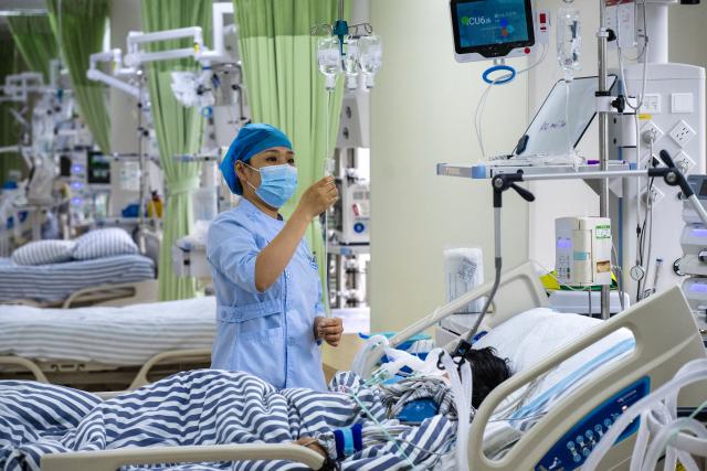 (261003) -- BEIJING, Oct. 3, 2026 (Xinhua) -- A nurse tends a patient inside an intensive care unit (ICU) at a hospital in Wuhu, east China's Anhui Province, Oct. 3, 2026.
  Many medical workers remain at their posts during the National Day holiday to provide healthcare services and safeguard public health. (Photo by Xiao Benxiang/Xinhua)