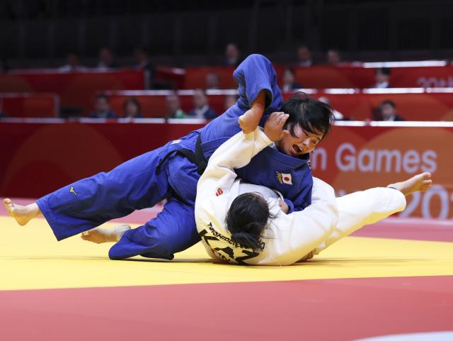 (261003) -- NAGOYA, Oct. 3, 2026 (Xinhua) -- Shirakane Mio (top) of team Japan competes with Meruyert Sarsenova of team Kazakhstan during the mixed team final of judo between Japan and Kazakhstan at the 20th Asian Games Aichi-Nagoya 2026 in Nagoya, Japan, Oct. 3, 2026. (Xinhua/Yao Qilin)