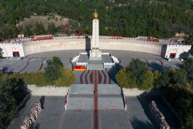 (261003) -- WUQI, Oct. 3, 2026 (Xinhua) -- A drone photo taken on Oct. 2, 2026 shows a view of the Memorial Park of the Central Red Army's Victory in the Long March in Wuqi County of Yan'an City, northwest China's Shaanxi Province.
  The year 2026 marks the 90th anniversary of the victory of the Central Red Army's Long March. Wuqi is the county where the Long March ended. Today, the county is home to many revolutionary sites. 
   The Long March was an epic military trek from 1934 to 1936, during which the Communist Party of China-led Red Army broke through encirclement by the Kuomintang forces. Red Army soldiers braved raging rivers, snow-covered mountains and treacherous grasslands, with some marching as far as 12,500 kilometers. The maneuver helped lay the foundation for the eventual victory of the Chinese revolution.
   The spirit of the Long March has been passed down through generations in Wuqi, inspiring local people to forge ahead and pursue development.        
   In the past, the county had long suffered from fragile environment, severe desertification and natural disasters. Since launching large-scale ecological restoration efforts in 1998, the county has seen its forest and grass coverage rate rise from 19.6 percent in 1997 to 72.9 percent at present, bringing significant improvements to the local environment. 
   Meanwhile, Wuqi has actively developed its apple industry. The apple orchards now cover 120,000 mu (about 8,000 hectares), helping increase farmers' incomes and promote rural revitalization. (Xinhua/Zou Jingyi)