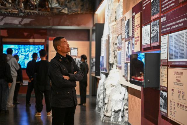 (261003) -- WUQI, Oct. 3, 2026 (Xinhua) -- Tourists visit the Memorial Museum of the Central Red Army's Victory in the Long March in Wuqi County of Yan'an City, northwest China's Shaanxi Province, Oct. 1, 2026.
  The year 2026 marks the 90th anniversary of the victory of the Central Red Army's Long March. Wuqi is the county where the Long March ended. Today, the county is home to many revolutionary sites. 
   The Long March was an epic military trek from 1934 to 1936, during which the Communist Party of China-led Red Army broke through encirclement by the Kuomintang forces. Red Army soldiers braved raging rivers, snow-covered mountains and treacherous grasslands, with some marching as far as 12,500 kilometers. The maneuver helped lay the foundation for the eventual victory of the Chinese revolution.
   The spirit of the Long March has been passed down through generations in Wuqi, inspiring local people to forge ahead and pursue development.        
   In the past, the county had long suffered from fragile environment, severe desertification and natural disasters. Since launching large-scale ecological restoration efforts in 1998, the county has seen its forest and grass coverage rate rise from 19.6 percent in 1997 to 72.9 percent at present, bringing significant improvements to the local environment. 
   Meanwhile, Wuqi has actively developed its apple industry. The apple orchards now cover 120,000 mu (about 8,000 hectares), helping increase farmers' incomes and promote rural revitalization. (Xinhua/Zou Jingyi)
