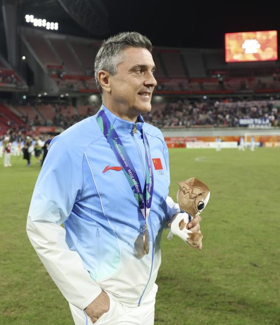 (261003) -- TOYOTA, Oct. 3, 2026 (Xinhua) -- Anthony Milicic, head coach of team China, reacts after the awarding ceremony for men's football event at 20th Asian Games Aichi-Nagoya 2026 in Toyota of Aichi Prefecture, Japan, Oct. 3, 2026. (Xinhua/Jia Haocheng)