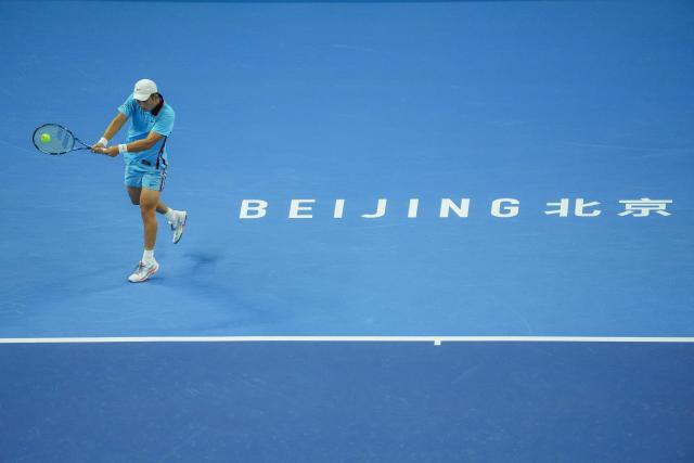 (261003) -- BEIJING, Oct. 3, 2026 (Xinhua) -- Shang Juncheng of China hits a return to Alexander Zverev of Germany during the men's singles second round match at 2026 China Open tennis tournament in Beijing, China, Oct. 3, 2026. (Xinhua/Xie Han)