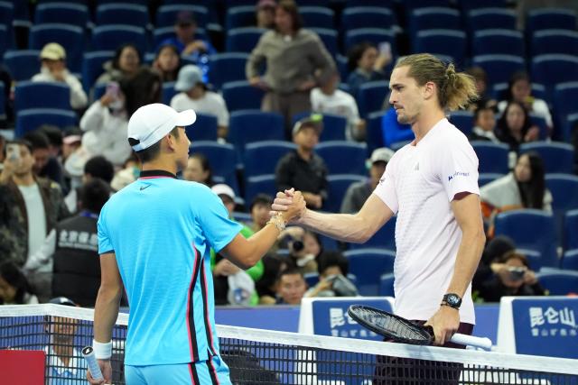 (261003) -- BEIJING, Oct. 3, 2026 (Xinhua) -- Shang Juncheng (L) of China greets Alexander Zverev of Germany after their men's singles second round match at 2026 China Open tennis tournament in Beijing, China, Oct. 3, 2026. (Xinhua/Xie Han)