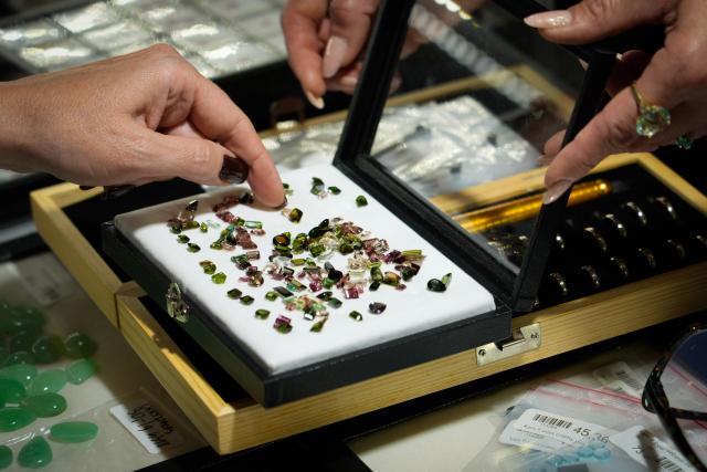 (261003) -- WARSAW, Oct. 3, 2026 (Xinhua) -- A visitor picks mineral stones at the Warsaw Mineral Expo in Warsaw, Poland, Oct. 3, 2026. The two-day expo kicked off on Saturday at the Palace of Culture and Science, bringing together nearly 300 exhibitors showcasing minerals, gemstones and jewelry. (Photo by Jaap Arriens/Xinhua)