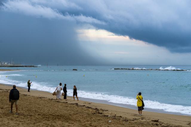 (261003) -- BARCELONA, Oct. 3, 2026 (Xinhua) -- People walk along the Sant Sebastia Beach during red alert for extreme weather in Barcelona, Spain, Oct. 3, 2026. (Photo by Joan Gosa/Xinhua)