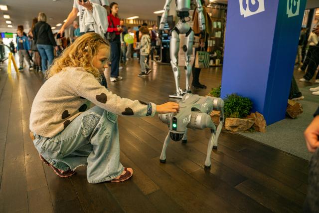 (261003) -- PRAGUE, Oct. 3, 2026 (Xinhua) -- A girl interacts with a robotic dog at the Prague Innovation Week in Prague, the Czech Republic, Oct. 3, 2026. Prague Innovation Week was held in the Czech capital Prague from October 1 to 3. (Photo by Dana Kesnerova/Xinhua)