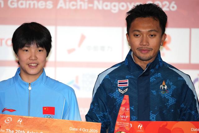 (261004) -- NAGOYA, Oct. 4, 2026 (Xinhua) -- Chinese swimmer Yu Zidi (L) and Thai sprinter Puripol Boonson pose with the awards for the most valuable player (MVP) of the 20th Asian Games during the awarding ceremony at the 20th Asian Games Aichi-Nagoya 2026 in Nagoya, Japan, Oct. 4, 2026. (Xinhua/Hou Zhaokang)