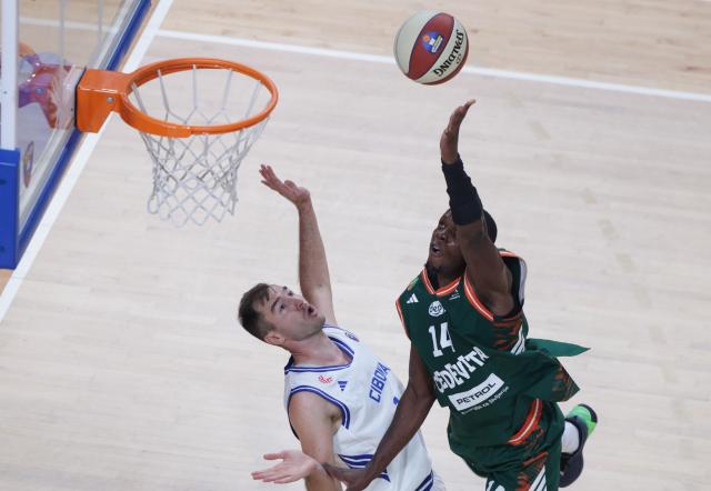 (261004) -- LJUBLJANA, Oct. 4, 2026 (Xinhua) -- Osayimwen Olugbenga Benson Osifo (R) of Cedevita Olimpija goes up to the basket during the ABA Basketball League Season 2026/27-Group A ROUND 2 match between Cedevita Olimpija and Cibona at Mala dvorana Tivoli in Ljubljana, Slovenia, Oct. 3, 2026. (Photo by Zeljko Stevanic/Xinhua)
