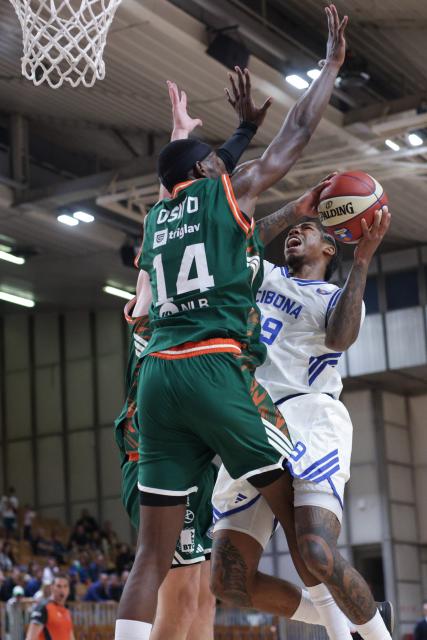 (261004) -- LJUBLJANA, Oct. 4, 2026 (Xinhua) -- Khalif Malik Battle (R) of Cibona vies with Osayimwen Olugbenga Benson Osifo (L) of Cedevita Olimpija during the ABA Basketball League Season 2026/27-Group A ROUND 2 match between Cedevita Olimpija and Cibona at Mala dvorana Tivoli in Ljubljana, Slovenia, Oct. 3, 2026. (Photo by Zeljko Stevanic/Xinhua)