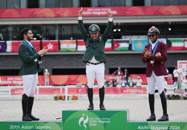 (261004) -- TOKYO, Oct. 4, 2026 (Xinhua) -- Gold medalist Ramzy Hamad Al Duhami (C) of Saudi Arabia celebrates as silver medalist Abdulrahman Bader M Alrajhi (L) of Saudi Arabia and bronze medalist Basem Mohammed of Qatar applaud him during the victory ceremony for the jumping Ind B (up to 1.55m) event of equestrian at the 20th Asian Games Aichi-Nagoya 2026 in Tokyo, Japan, Oct. 4, 2026. (Photo by Wang Shen/Xinhua)
