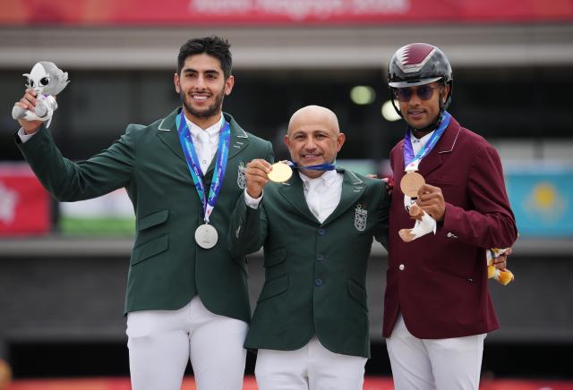 (261004) -- TOKYO, Oct. 4, 2026 (Xinhua) -- Gold medalist Ramzy Hamad Al Duhami (C) of Saudi Arabia, silver medalist Abdulrahman Bader M Alrajhi (L) of Saudi Arabia and bronze medalist Basem Mohammed of Qatar pose during the victory ceremony for the jumping Ind B (up to 1.55m) event of equestrian at the 20th Asian Games Aichi-Nagoya 2026 in Tokyo, Japan, Oct. 4, 2026. (Photo by Wang Shen/Xinhua)