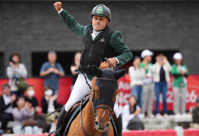 (261004) -- TOKYO, Oct. 4, 2026 (Xinhua) -- Ramzy Hamad Al Duhami of Saudi Arabia riding Untouchable 32 celebrates during the jumping Ind B (up to 1.55m) 2nd round of equestrian at the 20th Asian Games Aichi-Nagoya 2026 in Tokyo, Japan, Oct. 4, 2026. (Photo by Wang Shen/Xinhua)
