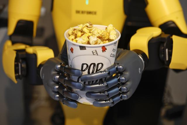 (261004) -- HEFEI, Oct. 4, 2026 (Xinhua) -- A robot makes popcorn at a store in Tunxi District of Huangshan, east China's Anhui Province, Oct. 1, 2026. During the National Day holiday, embodied AI robots of various functions rolled out in commercial and cultural blocks have been a major attraction for tourists. Through smart interactions, they have diversified tourism offerings and experiences. (Photo by Shi Yalei/Xinhua)