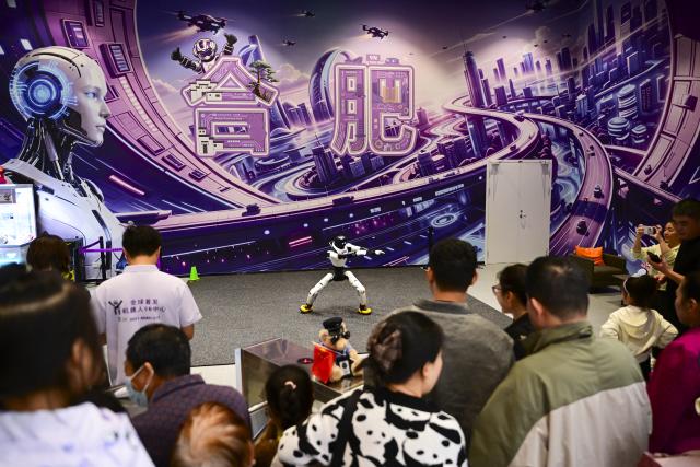 (261004) -- HEFEI, Oct. 4, 2026 (Xinhua) -- A robot performs martial arts in a public venue in Hefei, east China's Anhui Province, Oct. 3, 2026. During the National Day holiday, embodied AI robots of various functions rolled out in commercial and cultural blocks have been a major attraction for tourists. Through smart interactions, they have diversified tourism offerings and experiences. (Xinhua/Zhou Mu)