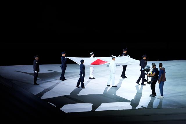 (261004) -- NAGOYA, Oct. 4, 2026 (Xinhua) -- Flag bearers carry the Japanese national flag during the closing ceremony of the 20th Asian Games Aichi-Nagoya 2026 in Nagoya, Japan, Oct. 4, 2026. (Xinhua/Cheong Kam Ka)