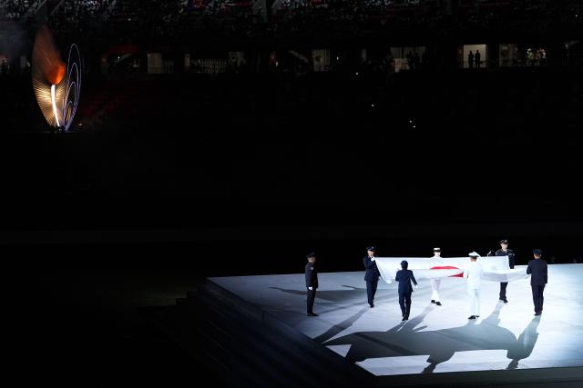 (261004) -- NAGOYA, Oct. 4, 2026 (Xinhua) -- Flag bearers carry the Japanese national flag during the closing ceremony of the 20th Asian Games Aichi-Nagoya 2026 in Nagoya, Japan, Oct. 4, 2026. (Xinhua/Cheong Kam Ka)