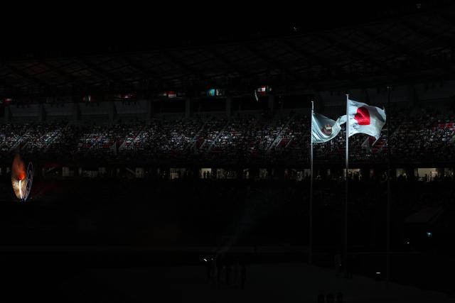(261004) -- NAGOYA, Oct. 4, 2026 (Xinhua) -- The national flag of Japan and flag of Olympic Council of Asia (OCA) are seen during the closing ceremony of the 20th Asian Games Aichi-Nagoya 2026 in Nagoya, Japan, Oct. 4, 2026. (Xinhua/Cheong Kam Ka)