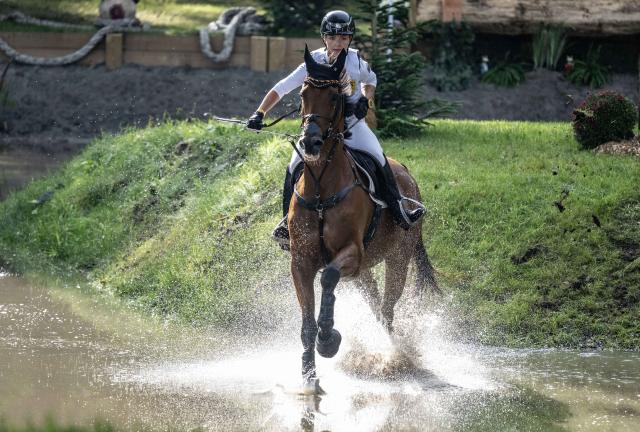 (261004) -- ENSCHEDE, Oct. 4, 2026 (Xinhua) -- A participant competes during the cross-country phase of the 55th Military Boekelo-Enschede in village Boekelo of Enschede, the Netherlands, Oct. 3, 2026. Military Boekelo-Enschede is a major international equestrian event held annually in Boekelo in the eastern Netherlands since 1971. The FEI four-star long-format eventing competition combines three disciplines: dressage, cross-country and show jumping. (Photo by Eric Brinkhorst/Xinhua)