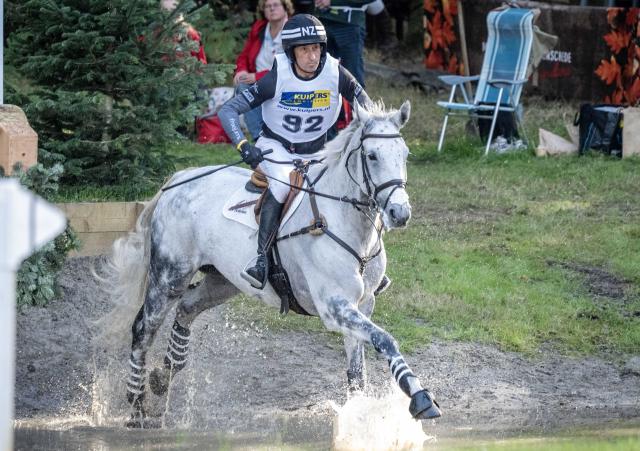 (261004) -- ENSCHEDE, Oct. 4, 2026 (Xinhua) -- A participant competes during the cross-country phase of the 55th Military Boekelo-Enschede in village Boekelo of Enschede, the Netherlands, Oct. 3, 2026. Military Boekelo-Enschede is a major international equestrian event held annually in Boekelo in the eastern Netherlands since 1971. The FEI four-star long-format eventing competition combines three disciplines: dressage, cross-country and show jumping. (Photo by Eric Brinkhorst/Xinhua)