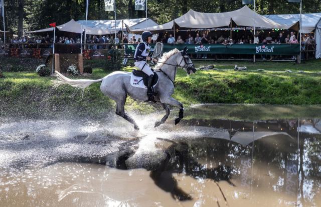(261004) -- ENSCHEDE, Oct. 4, 2026 (Xinhua) -- A participant competes during the cross-country phase of the 55th Military Boekelo-Enschede in village Boekelo of Enschede, the Netherlands, Oct. 3, 2026. Military Boekelo-Enschede is a major international equestrian event held annually in Boekelo in the eastern Netherlands since 1971. The FEI four-star long-format eventing competition combines three disciplines: dressage, cross-country and show jumping. (Photo by Eric Brinkhorst/Xinhua)