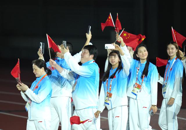(261004) -- NAGOYA, Oct. 4, 2026 (Xinhua) -- The delegation of China parade into the stadium during the closing ceremony of the 20th Asian Games Aichi-Nagoya 2026 in Nagoya, Japan, Oct. 4, 2026. (Xinhua/Wang Fei)