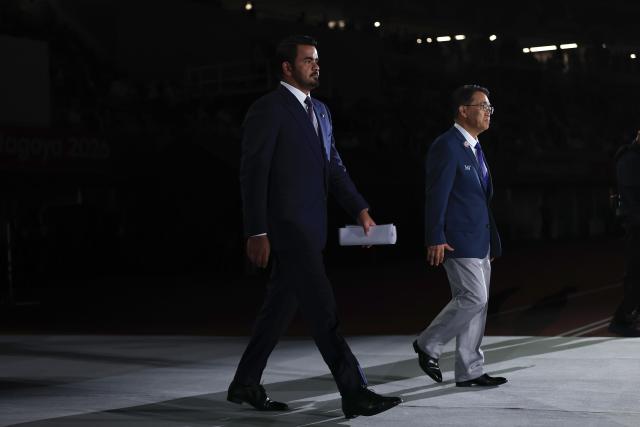 (261004) -- NAGOYA, Oct. 4, 2026 (Xinhua) -- Sheikh Joaan Bin Hamad Al Thani (L), president of the Olympic Council of Asia (OCA) and Ohmura Hideaki, president of the Aichi-Nagoya Asian Games and Asian Para Games Organizing Committee, walk in during the closing ceremony of the 20th Asian Games Aichi-Nagoya 2026 in Nagoya, Japan, Oct. 4, 2026. (Xinhua/Jia Haocheng)