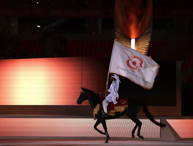 (261004) -- NAGOYA, Oct. 4, 2026 (Xinhua) -- Jassim Al Kuwari of Qatar holds the flag of Olympic Council of Asia (OCA) on a horse during the closing ceremony of the 20th Asian Games Aichi-Nagoya 2026 in Nagoya, Japan, Oct. 4, 2026. (Xinhua/Jia Haocheng)