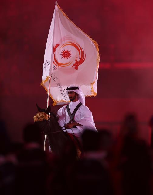 (261004) -- NAGOYA, Oct. 4, 2026 (Xinhua) -- Jassim Al Kuwari of Qatar holds the flag of Olympic Council of Asia (OCA) on a horse during the closing ceremony of the 20th Asian Games Aichi-Nagoya 2026 in Nagoya, Japan, Oct. 4, 2026. (Xinhua/Jia Haocheng)