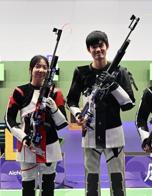 (261004) -- NAGOYA, Oct. 4, 2026 (Xinhua) -- Wang Zifei and Sheng Lihao (R) of team China react after the 10m air rifle mixed team final of Shooting at the 20th Asian Games Aichi-Nagoya 2026 in Toyota of Aichi Prefecture, Japan, Sept. 22, 2026. (Xinhua/Liu Lei)