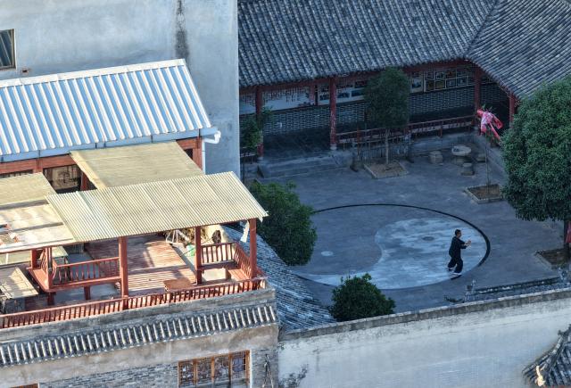 (261004) -- WENXIAN, Oct. 4, 2026 (Xinhua) -- An aerial drone photo taken on Sept. 3, 2026 shows a coach practicing Taijiquan in Chenjiagou Village of Wenxian County, central China's Henan Province. Social media users in the West have recently embraced "Chinamaxxing," in which young people show interest in aspects of Chinese daily life.
   Taijiquan, a kind of traditional martial arts, was born in the mid-17th century in Chenjiagou Village. Rooted in Chinese philosophy, traditional medicine and martial arts, Taijiquan has evolved into a wide range of styles and is now practiced in more than 180 countries and regions. For foreign visitors, Chenjiagou is naturally one of the best spots to experience the "Chinamaxxing" trend. The small village offers a tranquil and comfortable living environment which lets visitors get away from the busy pace of city life and immerse themselves in traditional Chinese culture. (Xinhua/Li Jianan)