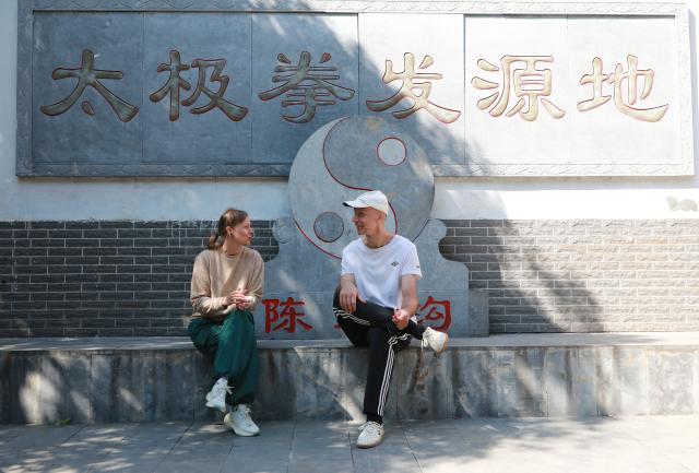 (261004) -- WENXIAN, Oct. 4, 2026 (Xinhua) -- Foreign Taijiquan enthusiasts communicate with each other in Chenjiagou Village of Wenxian County, central China's Henan Province, Oct. 2, 2026. Social media users in the West have recently embraced "Chinamaxxing," in which young people show interest in aspects of Chinese daily life.
   Taijiquan, a kind of traditional martial arts, was born in the mid-17th century in Chenjiagou Village. Rooted in Chinese philosophy, traditional medicine and martial arts, Taijiquan has evolved into a wide range of styles and is now practiced in more than 180 countries and regions. For foreign visitors, Chenjiagou is naturally one of the best spots to experience the "Chinamaxxing" trend. The small village offers a tranquil and comfortable living environment which lets visitors get away from the busy pace of city life and immerse themselves in traditional Chinese culture. (Photo by Huang Fuxing/Xinhua)