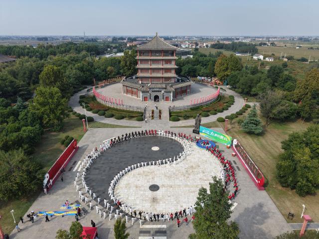 (261004) -- WENXIAN, Oct. 4, 2026 (Xinhua) -- An aerial drone photo taken on Oct. 2, 2026 shows Taijiquan enthusiasts practicing Taijiquan in front of the Taijiquan museum in Chenjiagou Village of Wenxian County, central China's Henan Province. Social media users in the West have recently embraced "Chinamaxxing," in which young people show interest in aspects of Chinese daily life.
   Taijiquan, a kind of traditional martial arts, was born in the mid-17th century in Chenjiagou Village. Rooted in Chinese philosophy, traditional medicine and martial arts, Taijiquan has evolved into a wide range of styles and is now practiced in more than 180 countries and regions. For foreign visitors, Chenjiagou is naturally one of the best spots to experience the "Chinamaxxing" trend. The small village offers a tranquil and comfortable living environment which lets visitors get away from the busy pace of city life and immerse themselves in traditional Chinese culture. (Photo by Xu Hongxing/Xinhua)